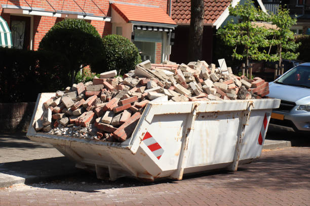 garbage dumpster filled wth old bricks near a construction site