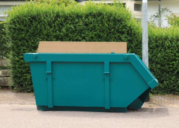 loaded dumpster near a construction site, a home renovation or maintenance